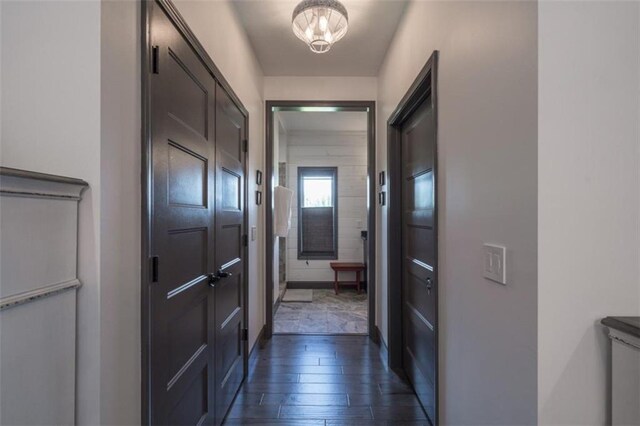 hall featuring a notable chandelier and dark hardwood / wood-style floors