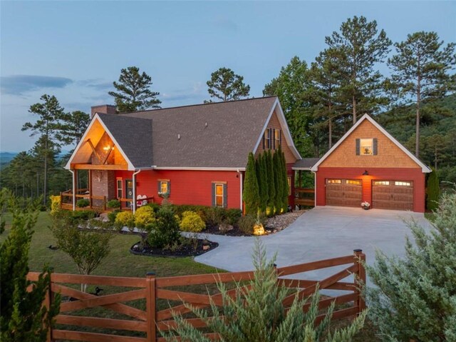 view of front of home featuring covered porch, an outdoor structure, and a garage