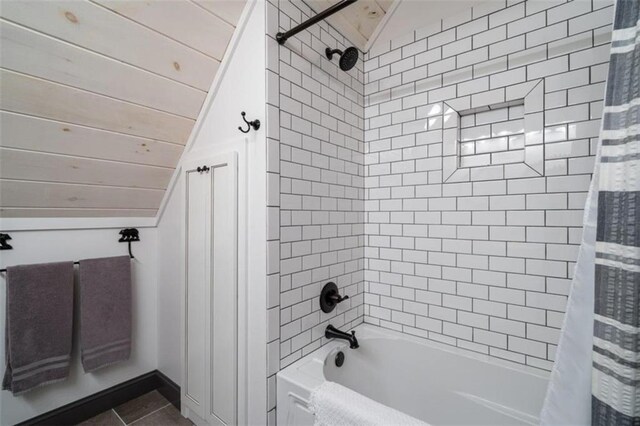 bathroom with shower / bath combo with shower curtain, lofted ceiling, and tile patterned floors