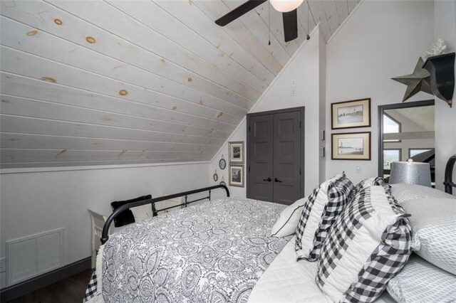 bedroom featuring ceiling fan, hardwood / wood-style floors, and vaulted ceiling