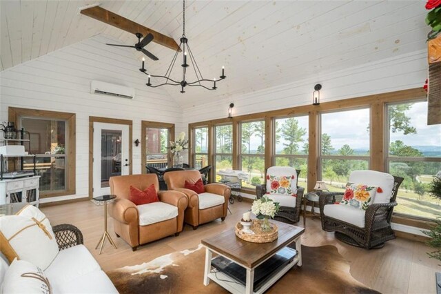 living room featuring light wood-type flooring, an AC wall unit, beamed ceiling, and high vaulted ceiling