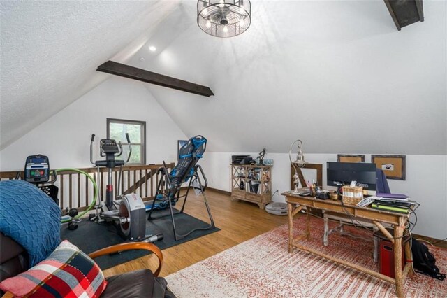 office space with a textured ceiling, vaulted ceiling with beams, and hardwood / wood-style flooring