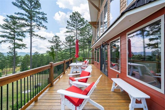 wooden deck with a lawn