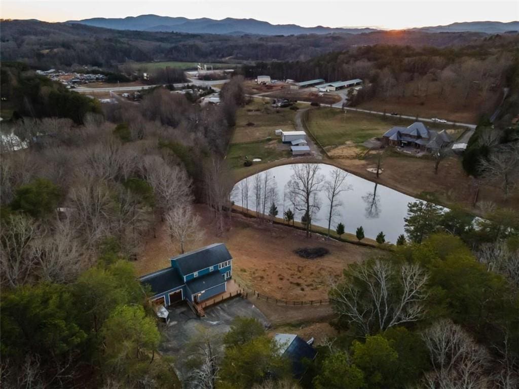 birds eye view of property featuring a water and mountain view