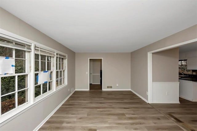 empty room featuring hardwood / wood-style flooring and plenty of natural light