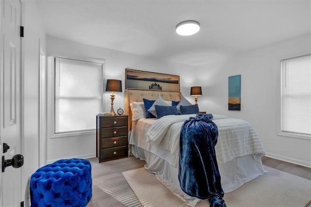 bedroom with wood finished floors and baseboards