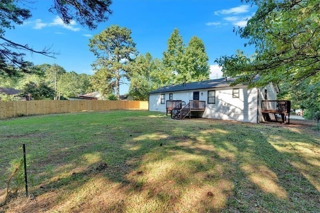 view of yard with fence and a deck