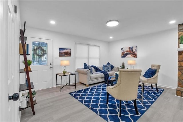 interior space with baseboards, wood finished floors, and recessed lighting