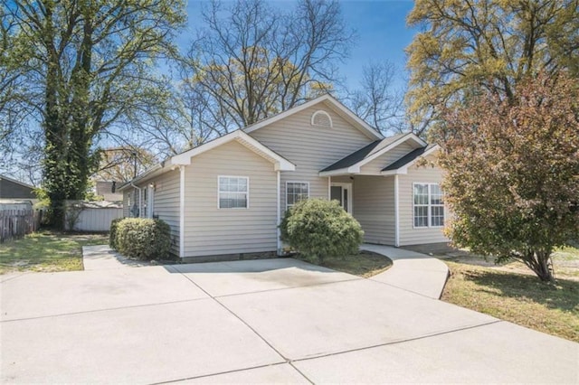single story home featuring fence