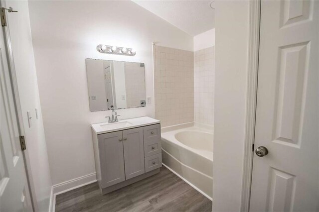 full bathroom with vanity and wood finished floors