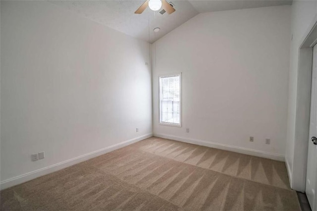 empty room featuring baseboards, a ceiling fan, lofted ceiling, and light colored carpet