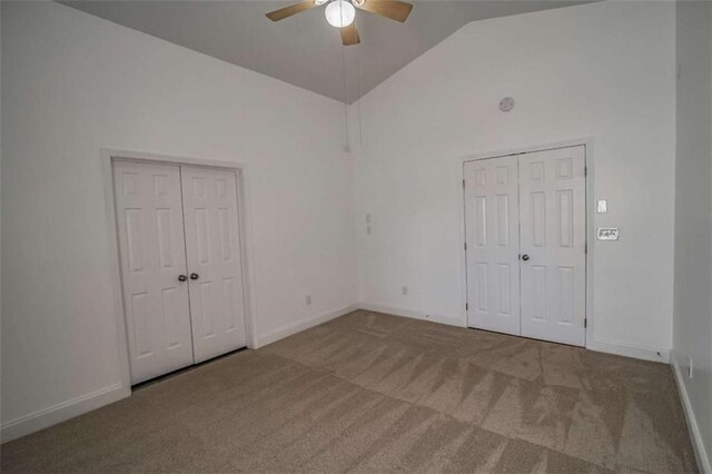 unfurnished bedroom with baseboards, carpet flooring, a ceiling fan, and high vaulted ceiling