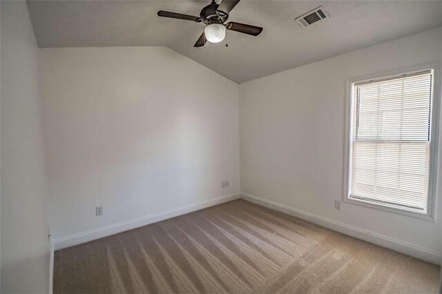 empty room with visible vents, a ceiling fan, baseboards, and light carpet