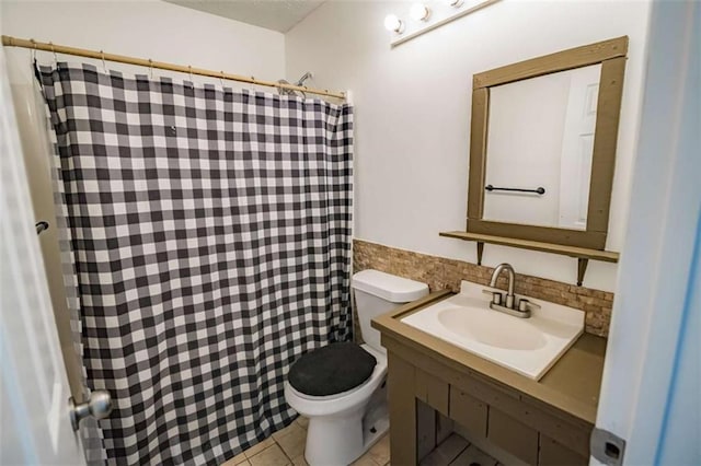 bathroom featuring tile patterned flooring, vanity, toilet, tile walls, and a shower with shower curtain