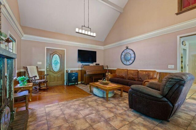 tiled living room featuring high vaulted ceiling and an inviting chandelier