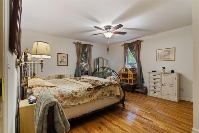 bedroom with ceiling fan and light hardwood / wood-style flooring