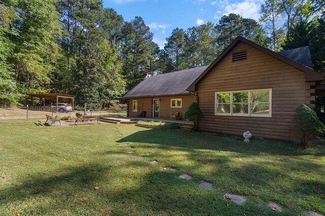 rear view of property featuring a lawn