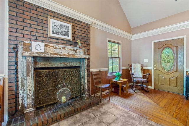 living area with light tile patterned floors, a fireplace, and vaulted ceiling