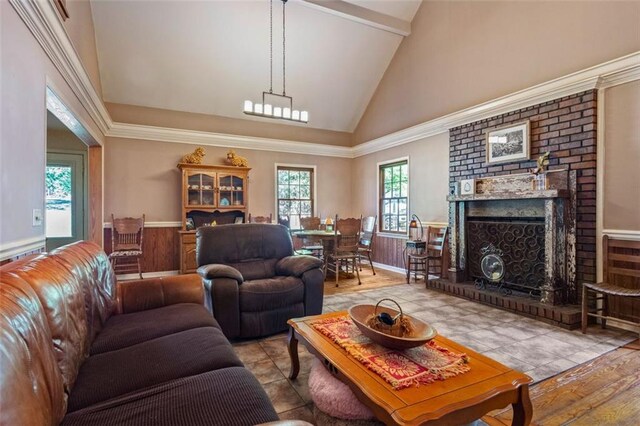 living room featuring high vaulted ceiling and a fireplace