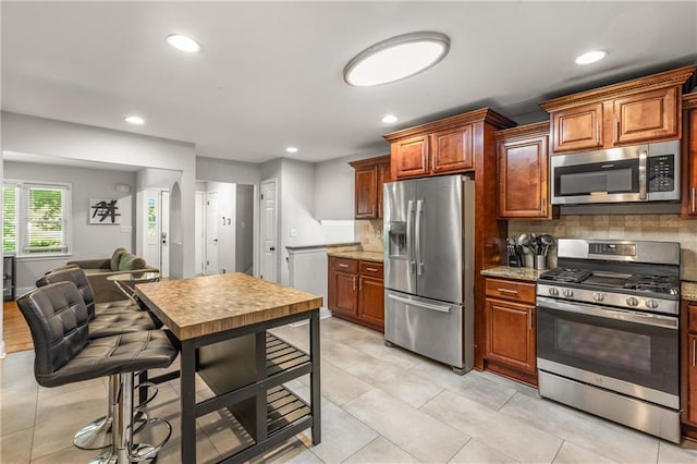 3307 Pointe Bleue Ct, Decatur, GA 30034 - kitchen featuring appliances with stainless steel finishes, backsplash, recessed lighting, light stone countertops, and light tile patterned floors