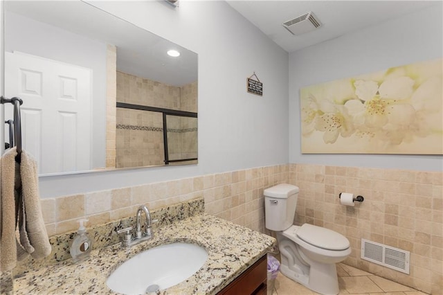 3307 Pointe Bleue Ct, Decatur, GA 30034 - full bath with tile walls, a stall shower, toilet, vanity, and tile patterned floors