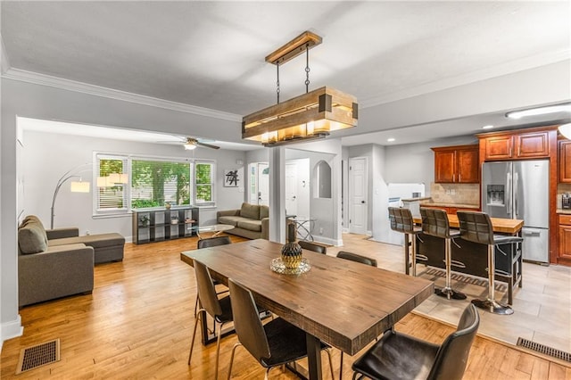 3307 Pointe Bleue Ct, Decatur, GA 30034 - dining space with ornamental molding, light wood-type flooring, a ceiling fan, baseboards, and arched walkways