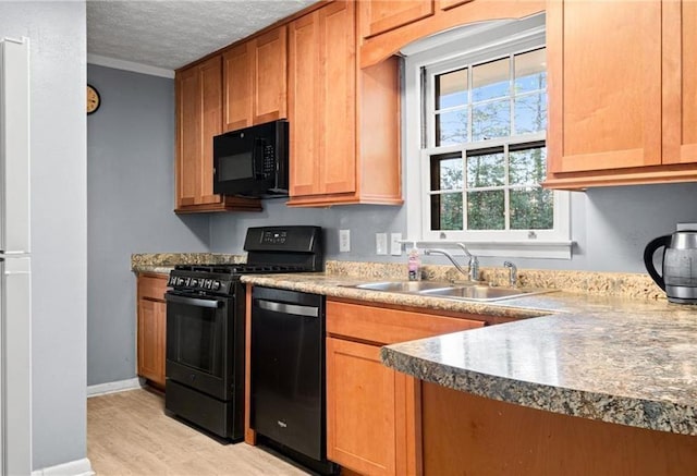 1729 Norden Rd, Riverdale, GA 30296 - kitchen featuring a sink, a textured ceiling, baseboards, black appliances, and light wood-style floors