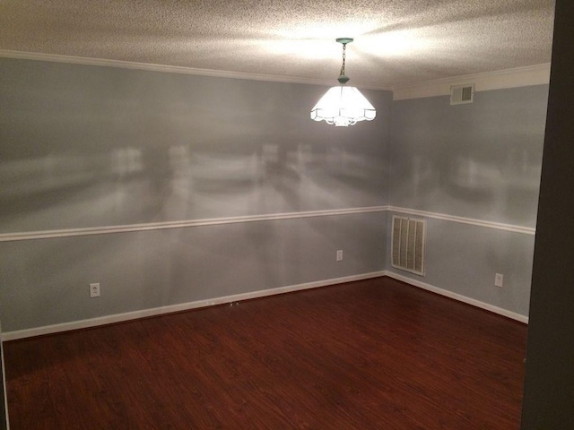 unfurnished room with crown molding, dark hardwood / wood-style floors, and a textured ceiling