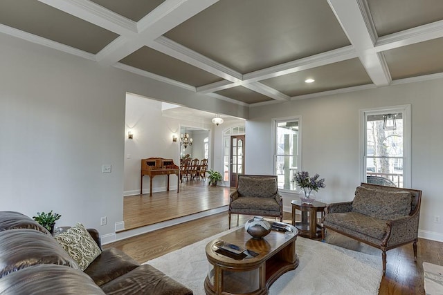 living room featuring coffered ceiling, a chandelier, and hardwood / wood-style floors