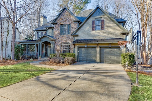 view of front of home featuring a garage, covered porch, and a front lawn