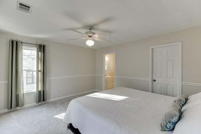 carpeted bedroom featuring ceiling fan and ensuite bath