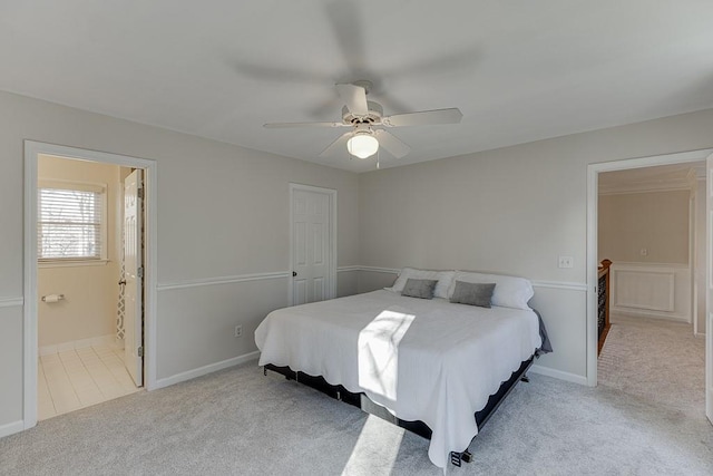 carpeted bedroom with ceiling fan and ensuite bath