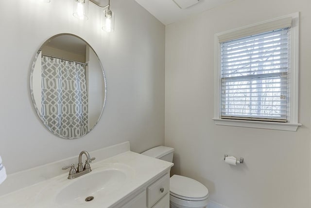 bathroom featuring vanity and toilet