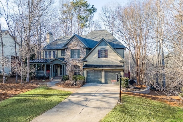 view of front of home featuring a garage, a porch, and a front lawn