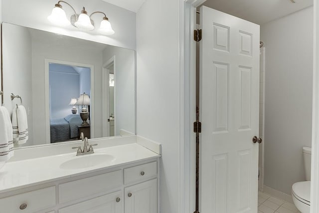 bathroom with vanity, tile patterned floors, and toilet