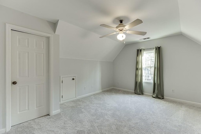 additional living space with ceiling fan, lofted ceiling, and light carpet