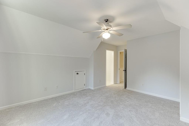 additional living space with lofted ceiling, light colored carpet, and ceiling fan