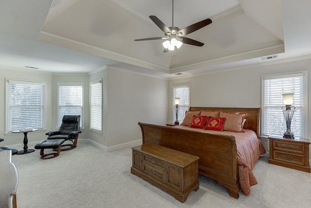 bedroom featuring ceiling fan, ornamental molding, a raised ceiling, and light carpet