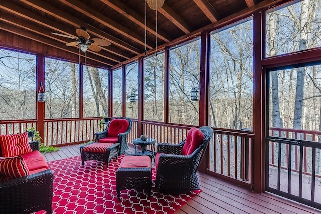 sunroom with beam ceiling and ceiling fan