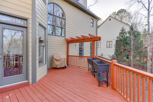 wooden deck featuring a grill