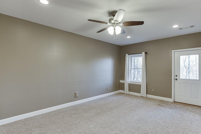 carpeted empty room featuring ceiling fan