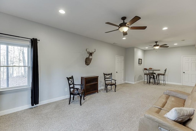 living room featuring light colored carpet and ceiling fan