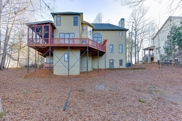 rear view of property with a wooden deck