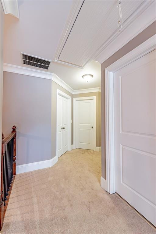 hallway featuring crown molding and light colored carpet