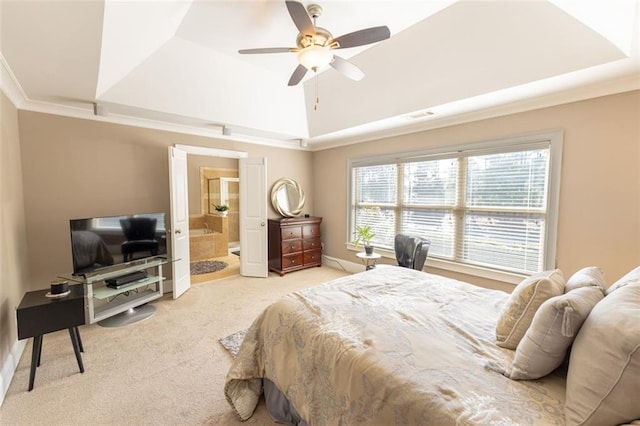 carpeted bedroom with ceiling fan, crown molding, connected bathroom, and a tray ceiling