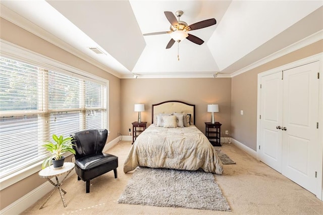 bedroom with carpet flooring, ceiling fan, lofted ceiling, and crown molding