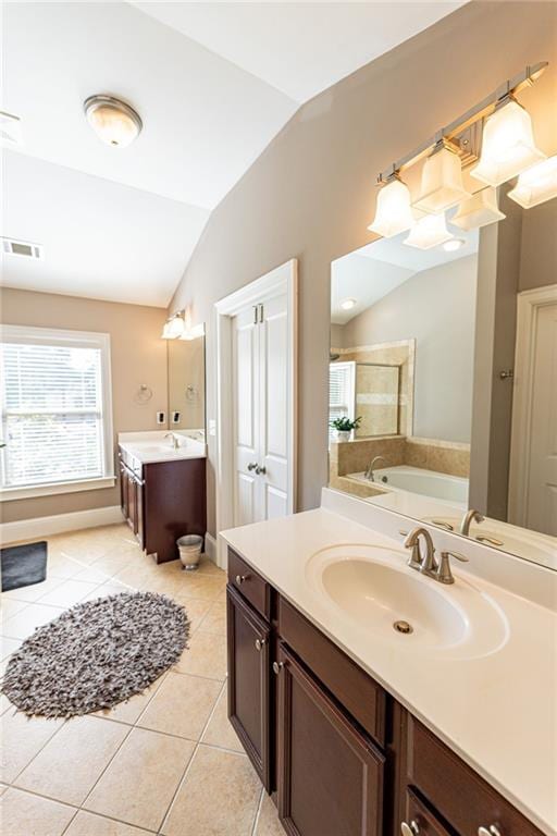 bathroom with tile patterned floors, vanity, plus walk in shower, and lofted ceiling