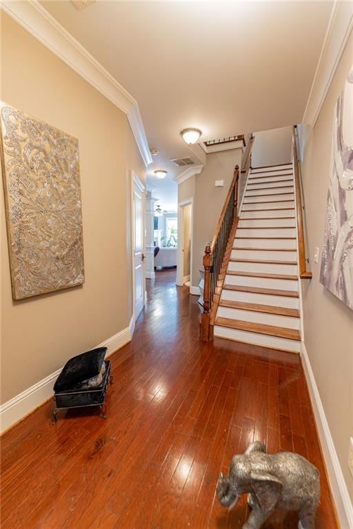 hallway featuring dark hardwood / wood-style floors and ornamental molding