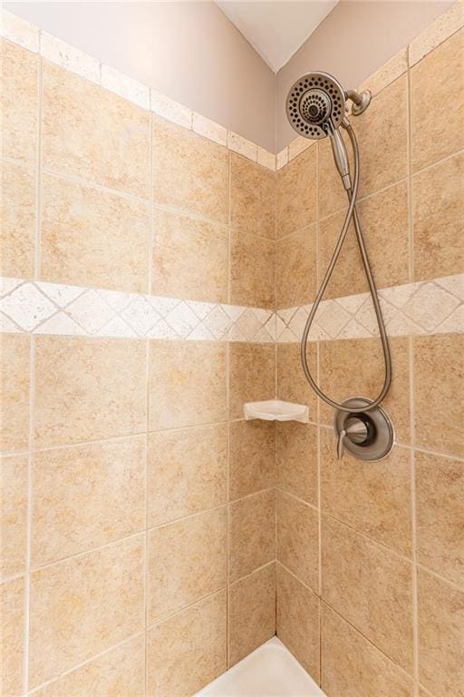 bathroom with tiled shower