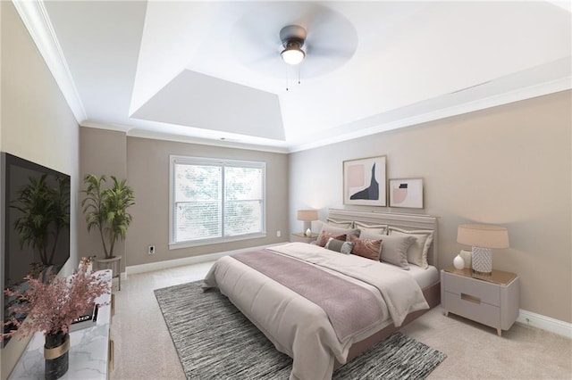 carpeted bedroom with a tray ceiling, ceiling fan, and crown molding